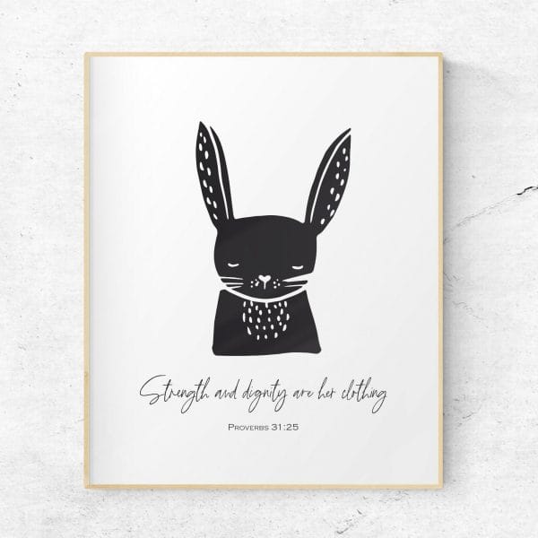 Scandinavian style black and white wall art featuring a cute rabbit in black and the verse "strength and dignity are her clothing" from Proverbs 31:25